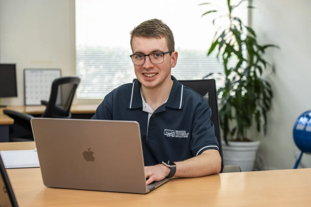 Alex working at his desk, Wagga Technology Solutions
