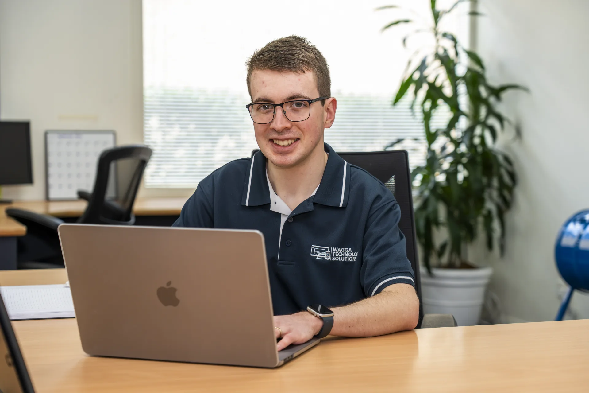 Alex working at his desk, Wagga Technology Solutions